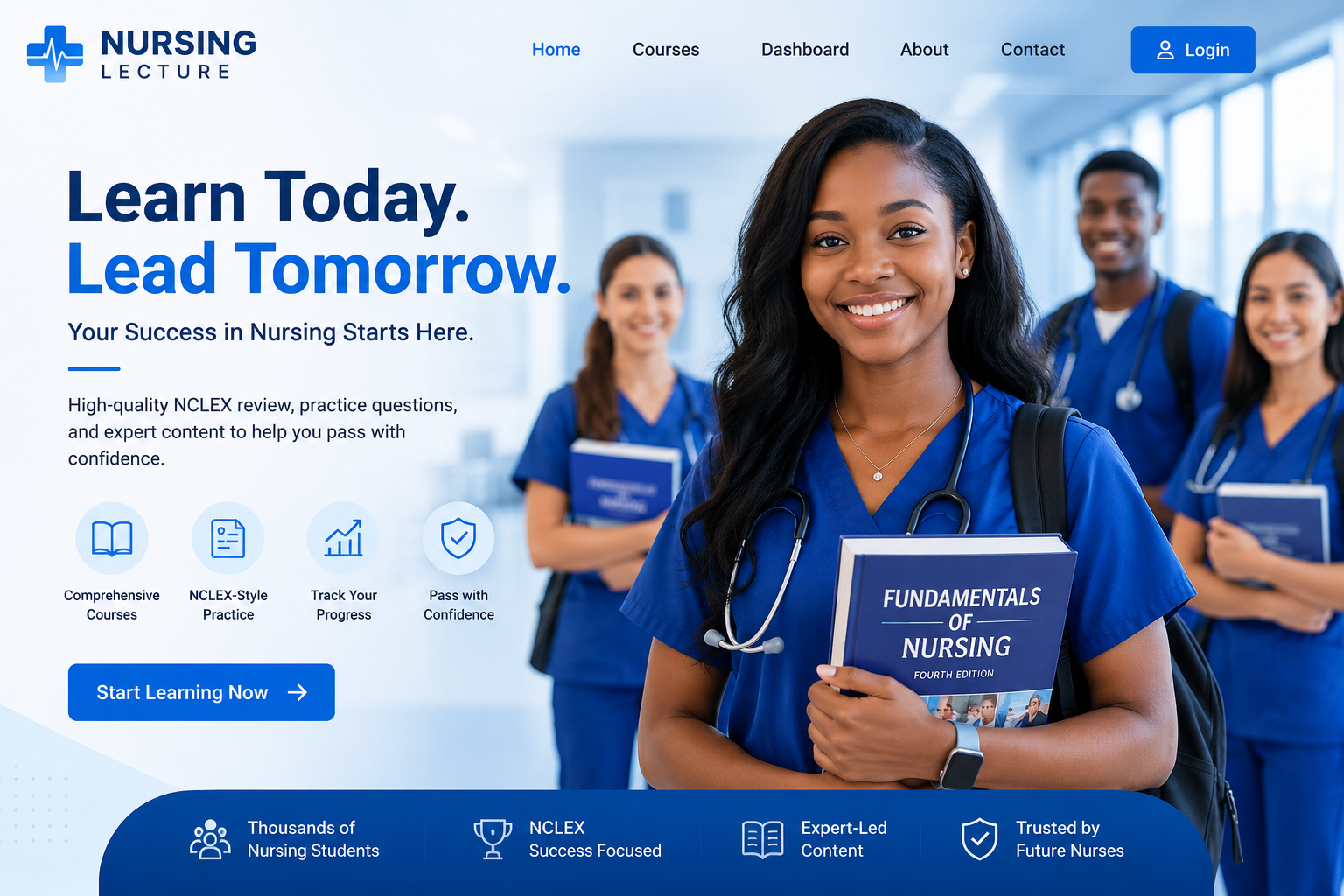 Nursing students in blue scrubs, one holding a Fundamentals of Nursing textbook, standing together in a bright clinical hallway